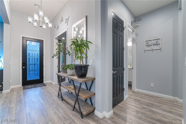 5865 Alice Landing Ct, Las Vegas, NV 89149 - foyer featuring light wood-type flooring, a chandelier, baseboards, and vaulted ceiling