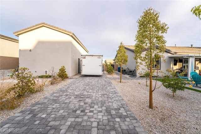 5865 Alice Landing Ct, Las Vegas, NV 89149 - rear view of property featuring stucco siding and a patio area
