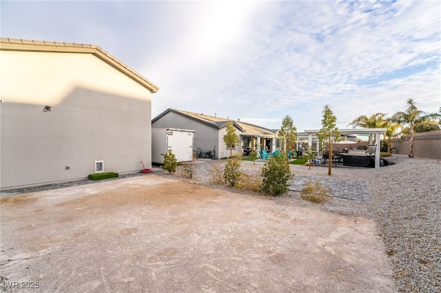 5865 Alice Landing Ct, Las Vegas, NV 89149 - view of home's exterior with a patio, a pergola, and a hot tub