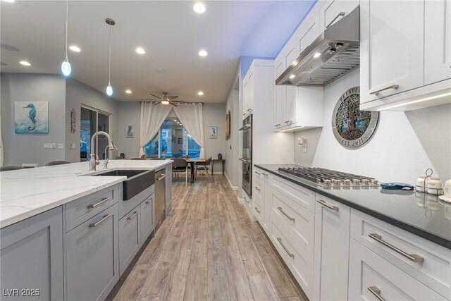 5865 Alice Landing Ct, Las Vegas, NV 89149 - kitchen featuring under cabinet range hood, a sink, recessed lighting, appliances with stainless steel finishes, and light stone countertops