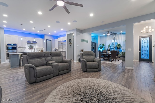 5865 Alice Landing Ct, Las Vegas, NV 89149 - living room with ceiling fan, wood finished floors, baseboards, recessed lighting, and a chandelier