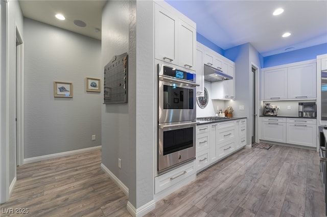 5865 Alice Landing Ct, Las Vegas, NV 89149 - kitchen featuring appliances with stainless steel finishes, wood finished floors, under cabinet range hood, white cabinets, and recessed lighting
