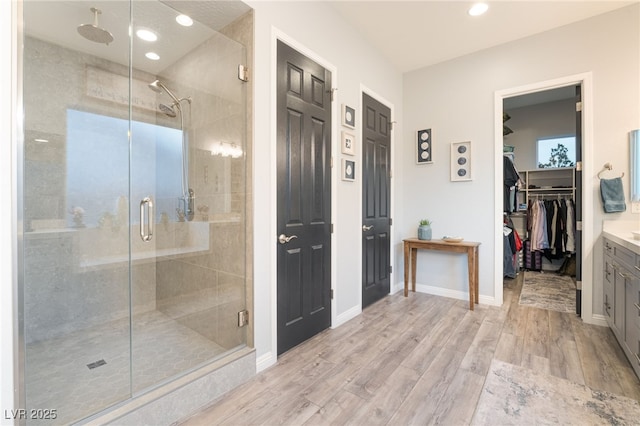 5865 Alice Landing Ct, Las Vegas, NV 89149 - full bathroom featuring a shower stall, vanity, wood finished floors, recessed lighting, and a walk in closet
