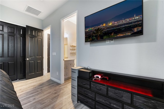 5865 Alice Landing Ct, Las Vegas, NV 89149 - bedroom with wood finished floors, connected bathroom, and baseboards