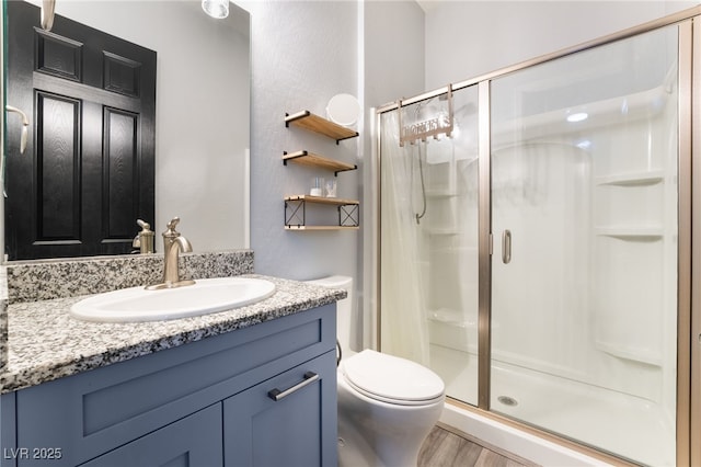 5865 Alice Landing Ct, Las Vegas, NV 89149 - full bathroom with a shower stall, wood finished floors, vanity, and toilet