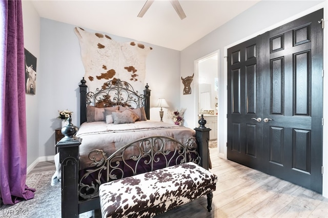 5865 Alice Landing Ct, Las Vegas, NV 89149 - bedroom with light wood-style floors, ensuite bathroom, ceiling fan, and baseboards
