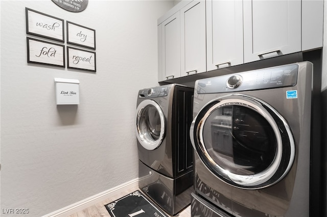 5865 Alice Landing Ct, Las Vegas, NV 89149 - laundry area featuring cabinet space, washer and dryer, baseboards, and wood finished floors