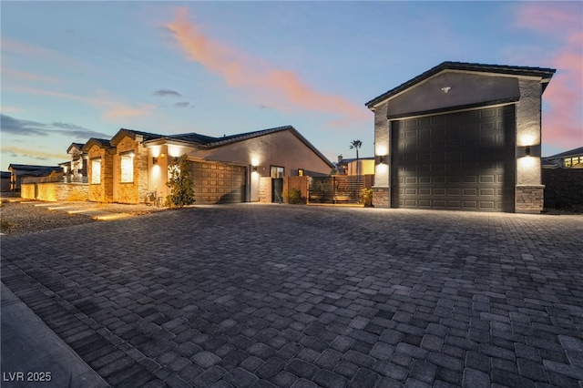 5865 Alice Landing Ct, Las Vegas, NV 89149 - contemporary home with decorative driveway, stucco siding, a garage, a gate, and stone siding