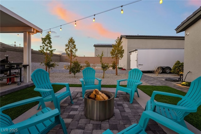 5865 Alice Landing Ct, Las Vegas, NV 89149 - patio terrace at dusk featuring a fire pit and a fenced backyard