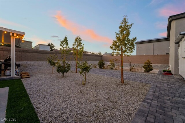 5865 Alice Landing Ct, Las Vegas, NV 89149 - yard at dusk featuring a patio and a fenced backyard