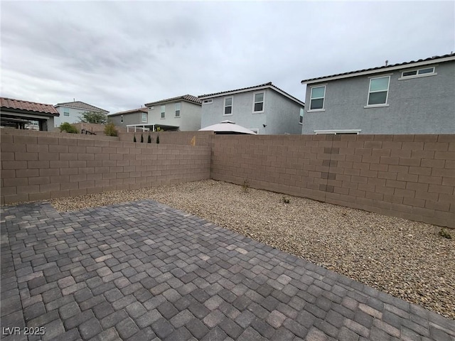 7672 Lush Oasis Ave, Las Vegas, NV 89113 - view of patio featuring a fenced backyard and a residential view
