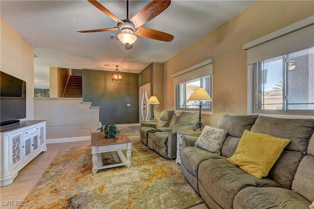 893 Fairway Dr, Boulder City, NV 89005 - living area with stairs, ceiling fan, light wood-style floors, a textured ceiling, and baseboards