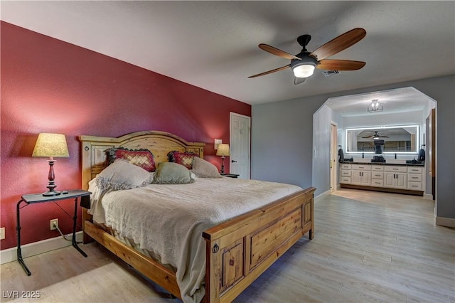 893 Fairway Dr, Boulder City, NV 89005 - bedroom featuring light wood-type flooring, baseboards, connected bathroom, and ceiling fan