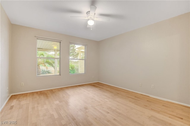 empty room with light wood-style floors, baseboards, and a ceiling fan