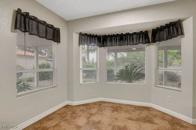 spare room featuring baseboards