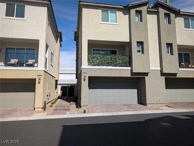 view of front of house featuring stucco siding and an attached garage