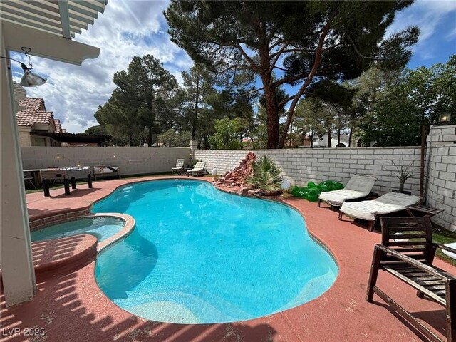 view of swimming pool with a fenced backyard, a patio, and a pool with connected hot tub