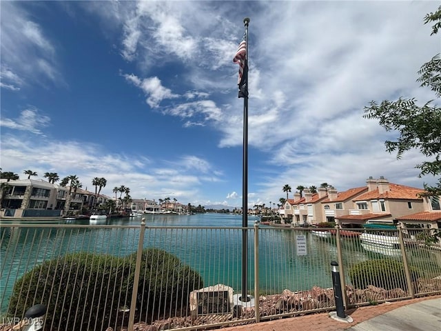 water view featuring fence and nearby suburban area