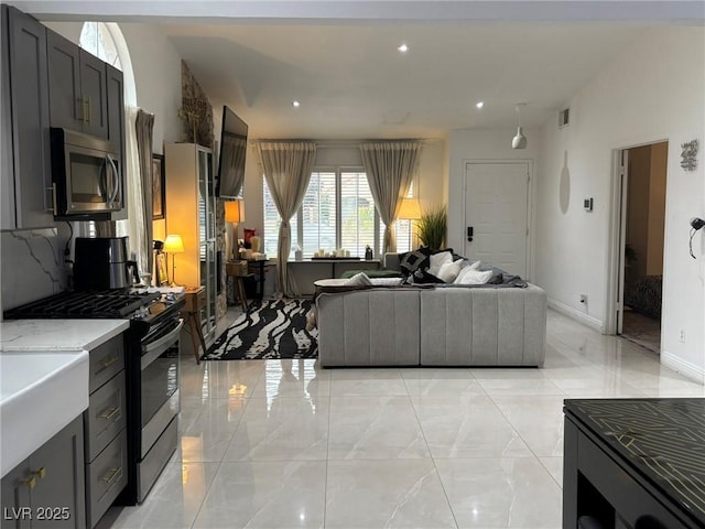 living room with light marble finish floors, baseboards, and recessed lighting