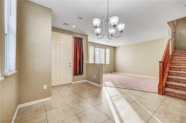 11420 Ogden Mills Dr Unit 101, Las Vegas, NV 89135 - unfurnished room featuring stairs, a chandelier, light tile patterned flooring, baseboards, and light colored carpet