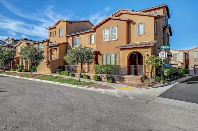 11420 Ogden Mills Dr Unit 101, Las Vegas, NV 89135 - view of front of property with a tile roof, stucco siding, and a residential view