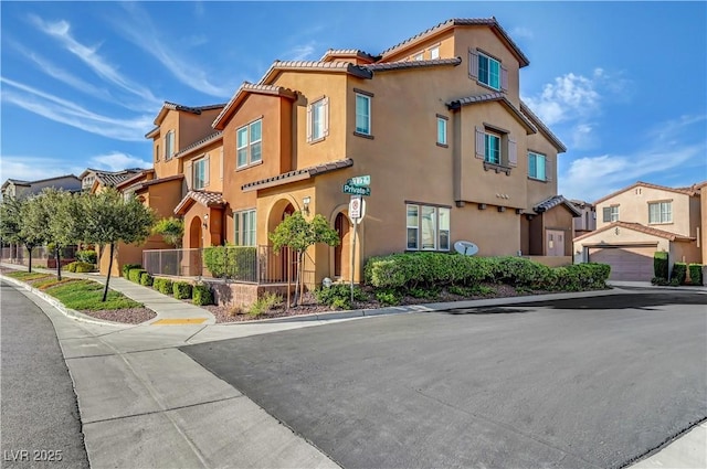 11420 Ogden Mills Dr Unit 101, Las Vegas, NV 89135 - mediterranean / spanish house with a tiled roof, stucco siding, and a residential view