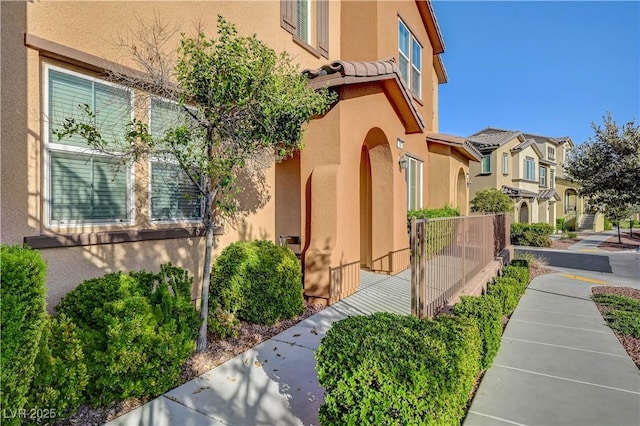 11420 Ogden Mills Dr Unit 101, Las Vegas, NV 89135 - view of side of home with stucco siding and a residential view