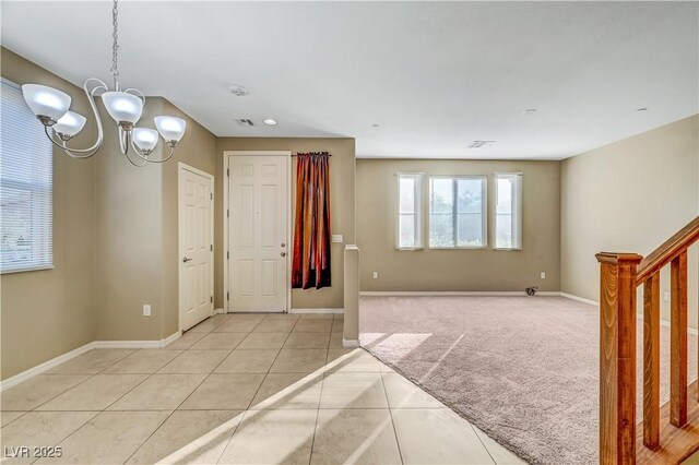 11420 Ogden Mills Dr Unit 101, Las Vegas, NV 89135 - foyer with a chandelier, baseboards, light tile patterned flooring, stairway, and light colored carpet