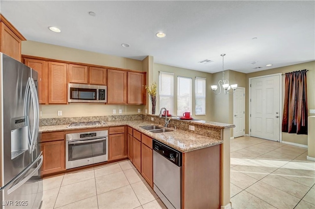 11420 Ogden Mills Dr Unit 101, Las Vegas, NV 89135 - kitchen with appliances with stainless steel finishes, a sink, a chandelier, a peninsula, and light stone countertops