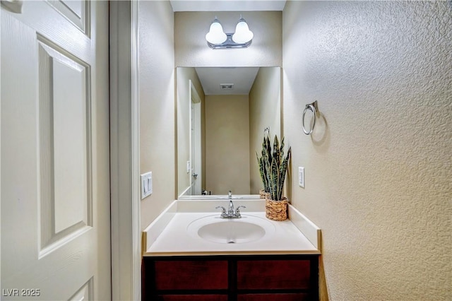 11420 Ogden Mills Dr Unit 101, Las Vegas, NV 89135 - bathroom featuring a textured wall and vanity