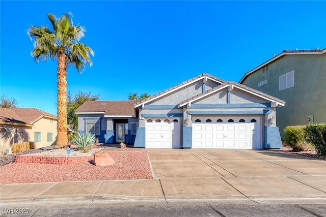 single story home with stucco siding, an attached garage, driveway, and a tile roof