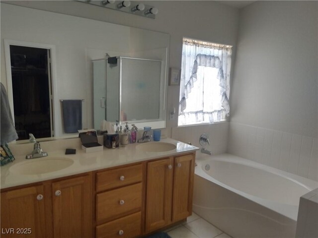 full bath with a shower stall, double vanity, a bath, and tile patterned floors