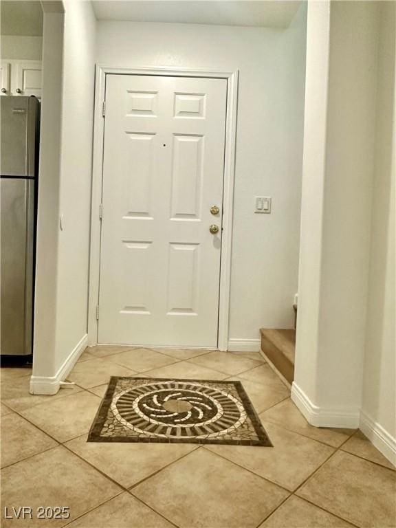 10372 Beautiful Fruit St, Las Vegas, NV 89183 - entrance foyer featuring baseboards, light tile patterned flooring, and stairway