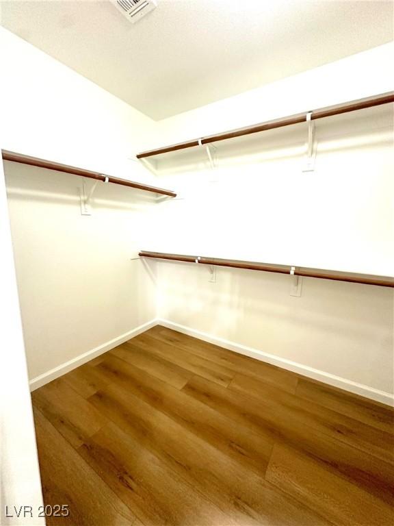spacious closet featuring wood finished floors
