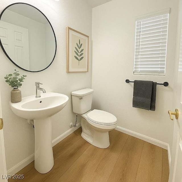 10372 Beautiful Fruit St, Las Vegas, NV 89183 - half bath featuring wood finished floors, baseboards, and toilet