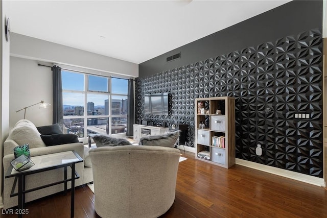 150 Las Vegas Blvd Unit 1608, Las Vegas, NV 89101 - living area with an accent wall, dark wood-style floors, wallpapered walls, and baseboards