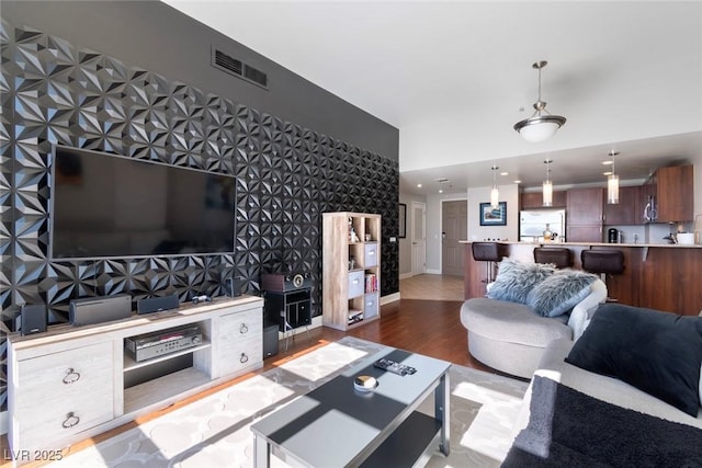 150 Las Vegas Blvd Unit 1608, Las Vegas, NV 89101 - living room with wood finished floors, wallpapered walls, an accent wall, baseboards, and recessed lighting