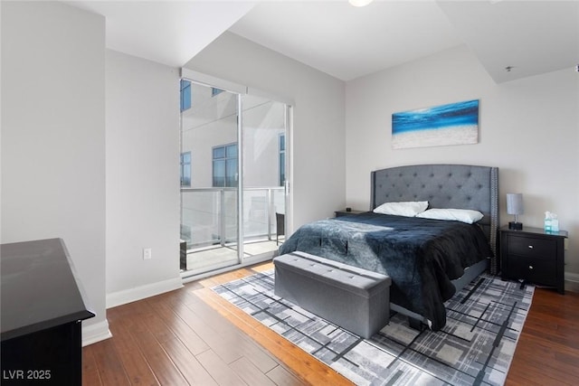 150 Las Vegas Blvd Unit 1608, Las Vegas, NV 89101 - bedroom featuring access to outside, hardwood / wood-style flooring, and baseboards