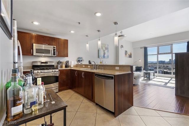 150 Las Vegas Blvd Unit 1608, Las Vegas, NV 89101 - kitchen with appliances with stainless steel finishes, a sink, a peninsula, pendant lighting, and recessed lighting