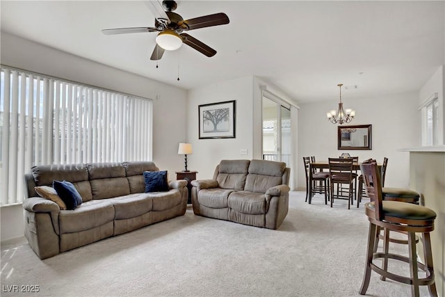 living room with a chandelier, carpet, and ceiling fan