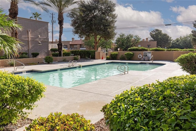 community pool featuring a patio area and fence