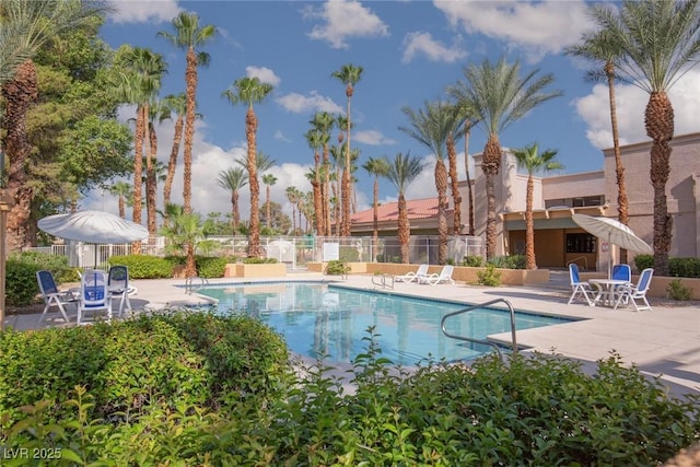 community pool featuring a patio and fence