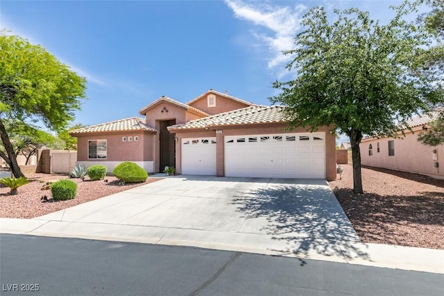 9524 Tyler Rose St, Las Vegas, NV 89178 - mediterranean / spanish house with a garage, concrete driveway, stucco siding, and a tiled roof