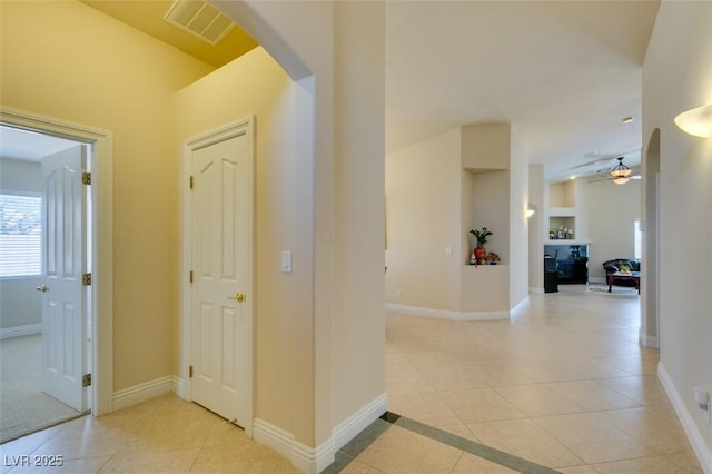 9524 Tyler Rose St, Las Vegas, NV 89178 - corridor featuring light tile patterned floors, arched walkways, and baseboards