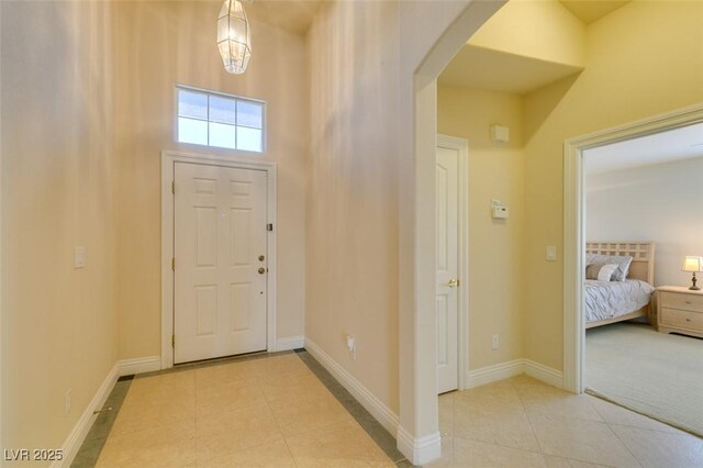9524 Tyler Rose St, Las Vegas, NV 89178 - entryway featuring tile patterned floors, arched walkways, and baseboards