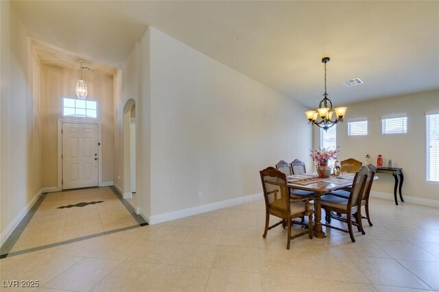 9524 Tyler Rose St, Las Vegas, NV 89178 - dining room with a chandelier, light tile patterned floors, arched walkways, and baseboards