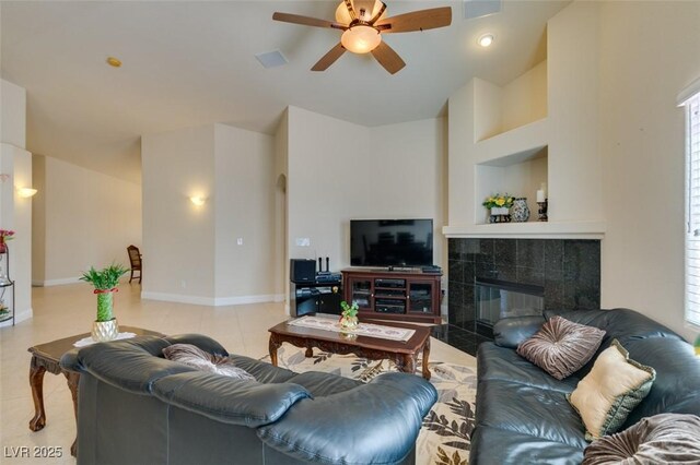 9524 Tyler Rose St, Las Vegas, NV 89178 - living room with a ceiling fan, a tiled fireplace, built in features, and baseboards