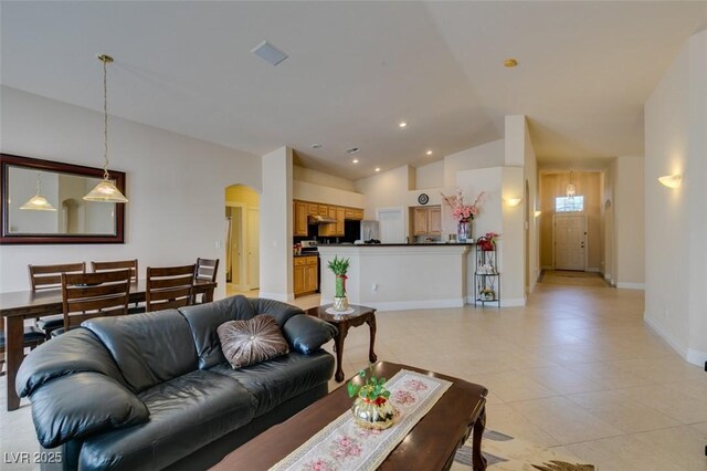 9524 Tyler Rose St, Las Vegas, NV 89178 - living area with arched walkways, lofted ceiling, baseboards, light tile patterned floors, and recessed lighting