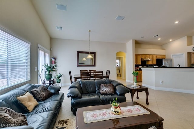 9524 Tyler Rose St, Las Vegas, NV 89178 - living area with arched walkways, light tile patterned floors, recessed lighting, and baseboards