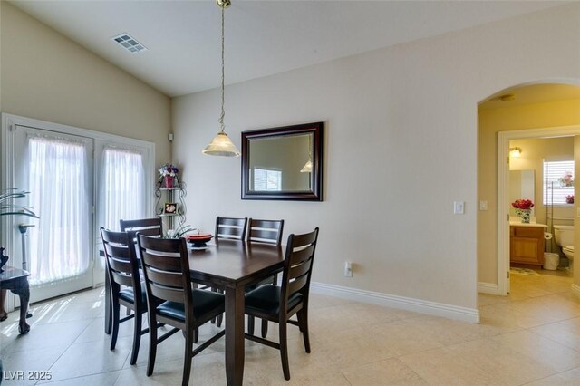 9524 Tyler Rose St, Las Vegas, NV 89178 - dining room with arched walkways, light tile patterned floors, and baseboards